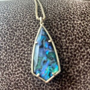 Kendra Scott gold chain with beautiful pendant blue, green, and black colors.
